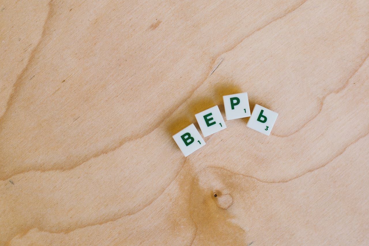 Cyrillic alphabet tiles spelling a word on a smooth wooden surface.